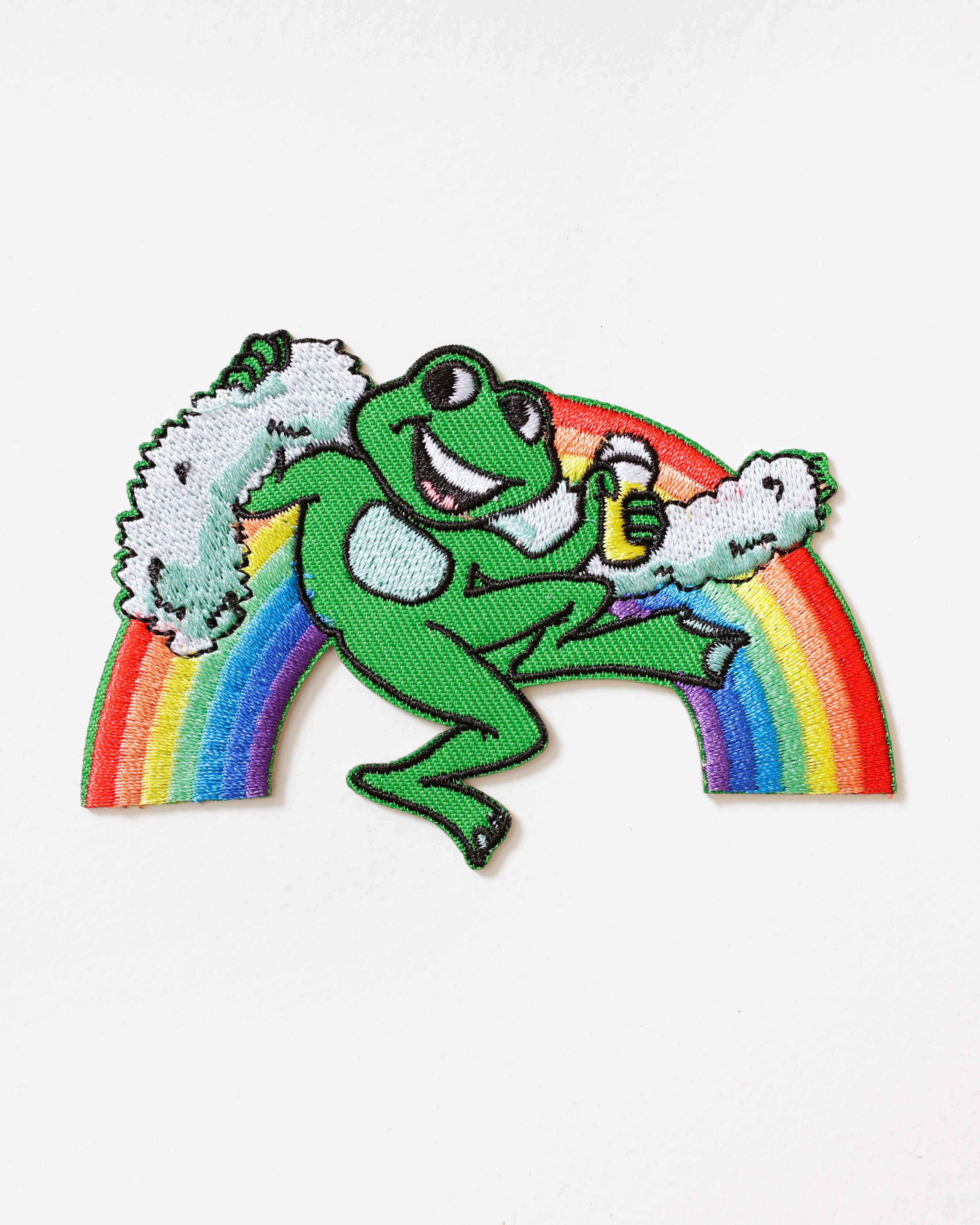 Embleem Oetel op Regenboog – Relaxte Kikker