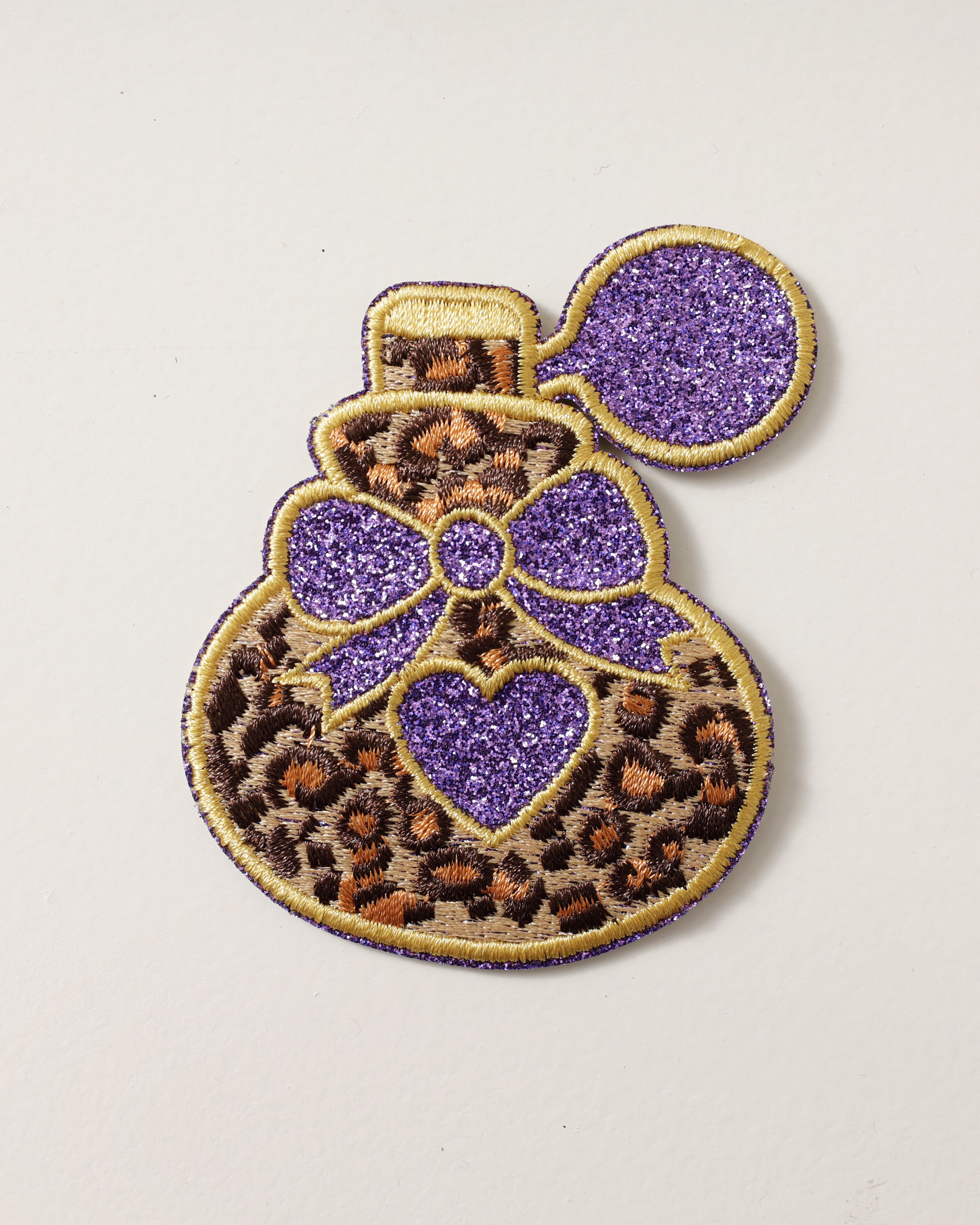 Embleem parfum flacon panterprint paars