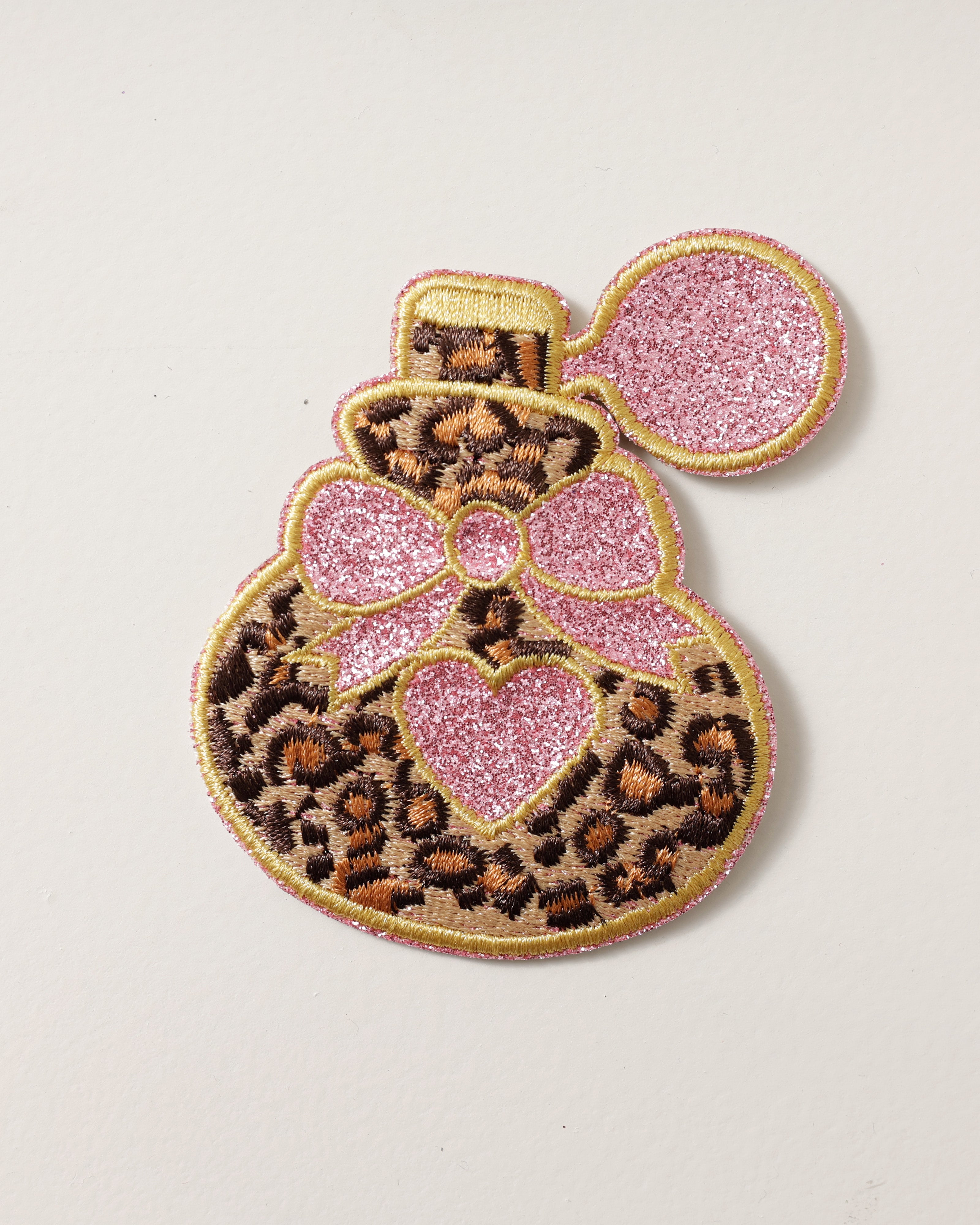 Embleem parfum flacon panterprint roze